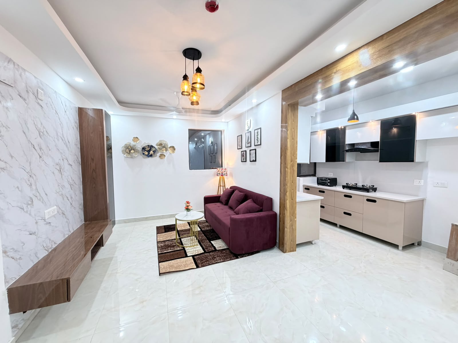 Same living area furnished with a sofa, rug, and decor after Eastern Yard furnishing